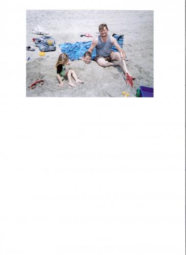 Look! They covered my big brother in sand!!